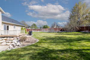 View of yard with a fenced backyard and a deck