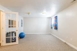 Workout area featuring baseboards, carpet flooring, and visible vents