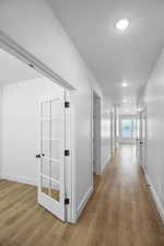 Hall featuring baseboards and wood finished floors