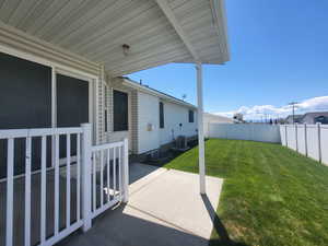 View of yard with a fenced backyard, a patio area, and cooling unit