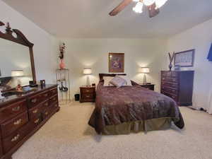 Bedroom featuring light carpet and a ceiling fan