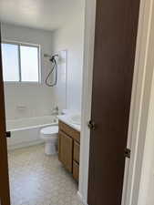 Bathroom featuring bathing tub / shower combination, vanity, and toilet