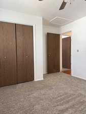 Unfurnished bedroom with baseboards, ceiling fan, a closet, and carpet flooring