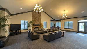 CLUB HOUSE: Carpeted living room featuring a chandelier, recessed lighting, high vaulted ceiling, and baseboards