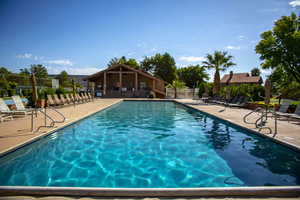 Pool with a patio and fence