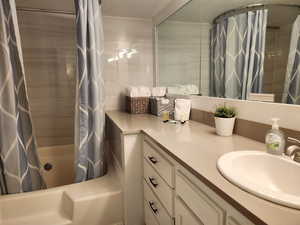 Full bath featuring vanity and shower / tub combo with curtain