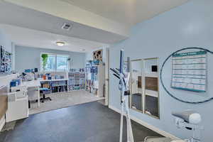 Office area with baseboards and visible vents