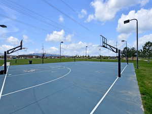 View of sport court with a yard and community basketball court