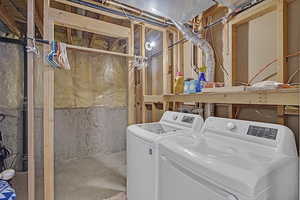 Washroom featuring laundry area and washer and dryer