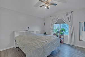 Bedroom featuring a textured ceiling, visible vents, and wood finished floors