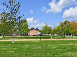 View of home's community with a yard and volleyball court
