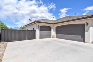 Exterior space featuring a tiled roof, an attached garage, driveway, and stucco siding