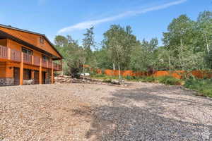 View of yard with fence and a garage