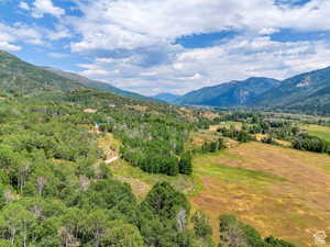 Property view of mountains featuring a wooded view