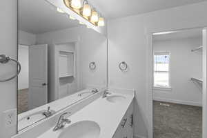 Full bathroom featuring double vanity and a sink