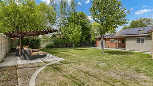 View of yard featuring a fenced backyard, a patio area, and an outdoor hangout area