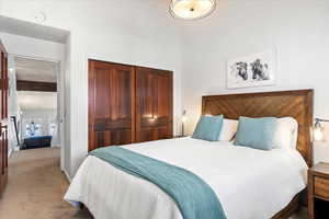 Carpeted bedroom with a closet