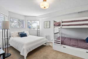Bedroom with carpet floors and visible vents
