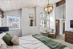 Bedroom featuring wood ceiling, carpet, a chandelier, and lofted ceiling