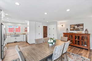 Dining space with recessed lighting and light wood-type flooring