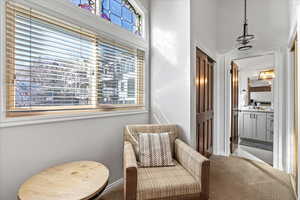 Living area with baseboards and carpet flooring