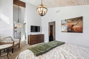 Bedroom featuring a notable chandelier, carpet floors, high vaulted ceiling, visible vents, and wood ceiling