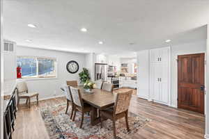 Dining room featuring visible vents, recessed lighting, baseboards, and light wood-style floors