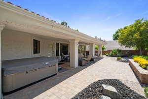 View of patio / terrace with a hot tub, a fenced backyard, and outdoor dining space