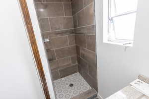 Full bath with a tile shower