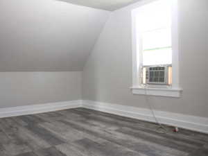 Alternate view of Bedroom #3 with built in storage, lofted ceiling, waterproof finished floors, a textured ceiling, and baseboards  in White Door unit 2.