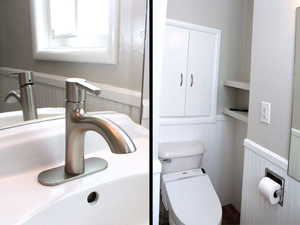 Bathroom featuring wainscoting, toilet, and brand new faucet with new vanity lights in White Door unit 2.