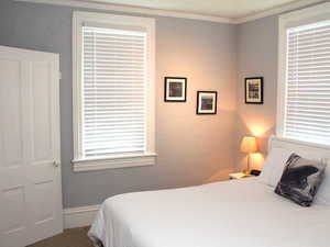 Carpeted bedroom with ensuite bathroom in 1-bed Red Door unit.  Unit comes with everything you see in the photo