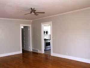Whited door unit 2 living room with ceiling fan, baseboards, and ornamental crown molding
