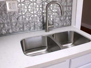 Kitchen Interior details with a sink and light stone counters in White door unit 2.