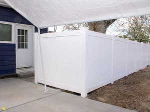 View of back door in White Door unit featuring new vinyl fence.