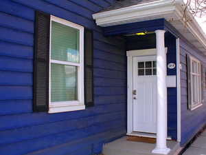 3rd view of front door to 3 bed unit.  White door is a separate entrance and NOT connected to Red door 1 bed front unit.