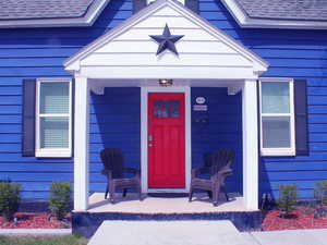 Front of House. Red door is 1-bed unit