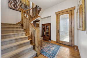 Entrance foyer with wood-type flooring, baseboards, and a healthy amount of sunlight