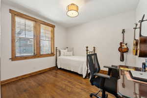 Bedroom featuring baseboards and wood finished floors