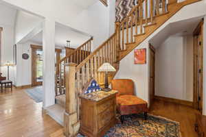 Stairway with wood-type flooring and baseboards