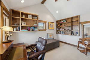 Carpeted office space with vaulted ceiling with beams, recessed lighting, and a ceiling fan