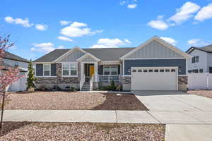 Craftsman-style home featuring a porch, a garage,