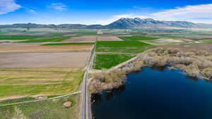 Birds eye view of property featuring a water and mountain view