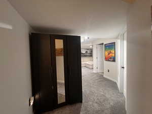 Hallway featuring carpet flooring