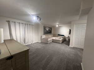 Living room featuring baseboards and carpet