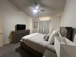 Bedroom with baseboards, a ceiling fan, carpet, and vaulted ceiling