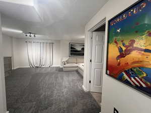 Interior space with baseboards and rail lighting