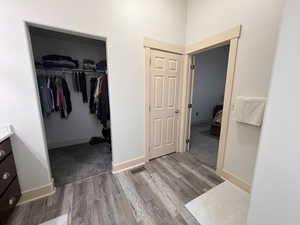 Bathroom with baseboards, visible vents, wood finished floors, and vanity