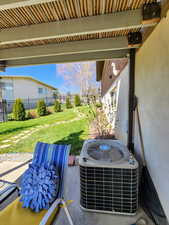 Exterior details with stucco siding, central air condition unit, and fence