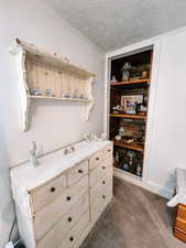 Room details with crown molding, a textured ceiling, and carpet